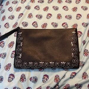 Unknown brand silver studded clutch in black with and attached strap.